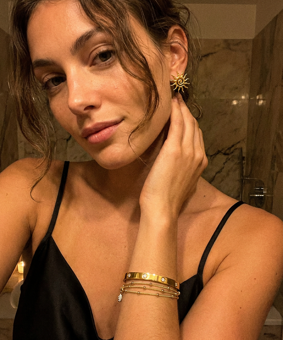 Solea Earrings worn — sculptural gold sun studs, waterproof and hypoallergenic